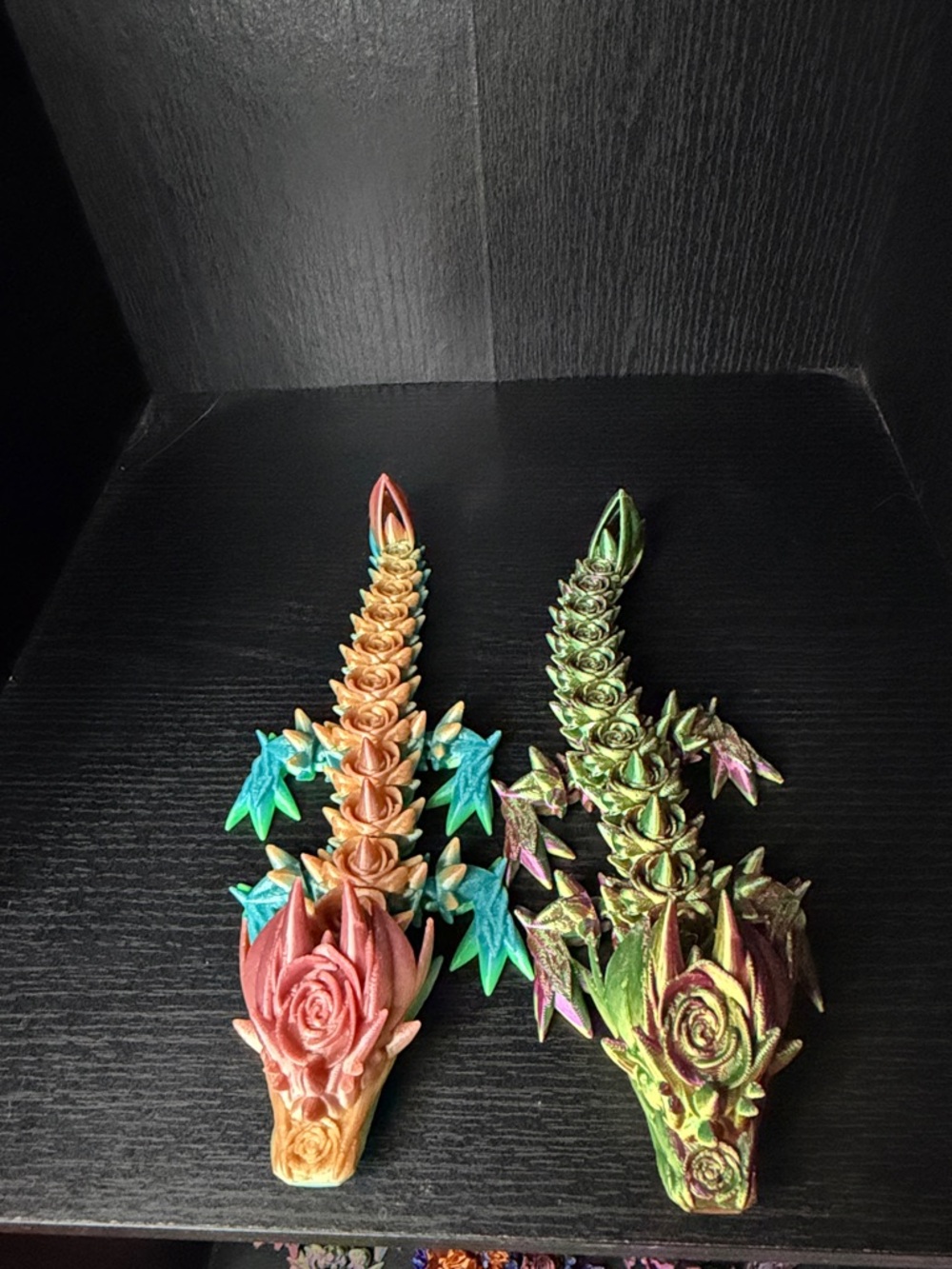 Two 3D printed rose dragons small-medium size